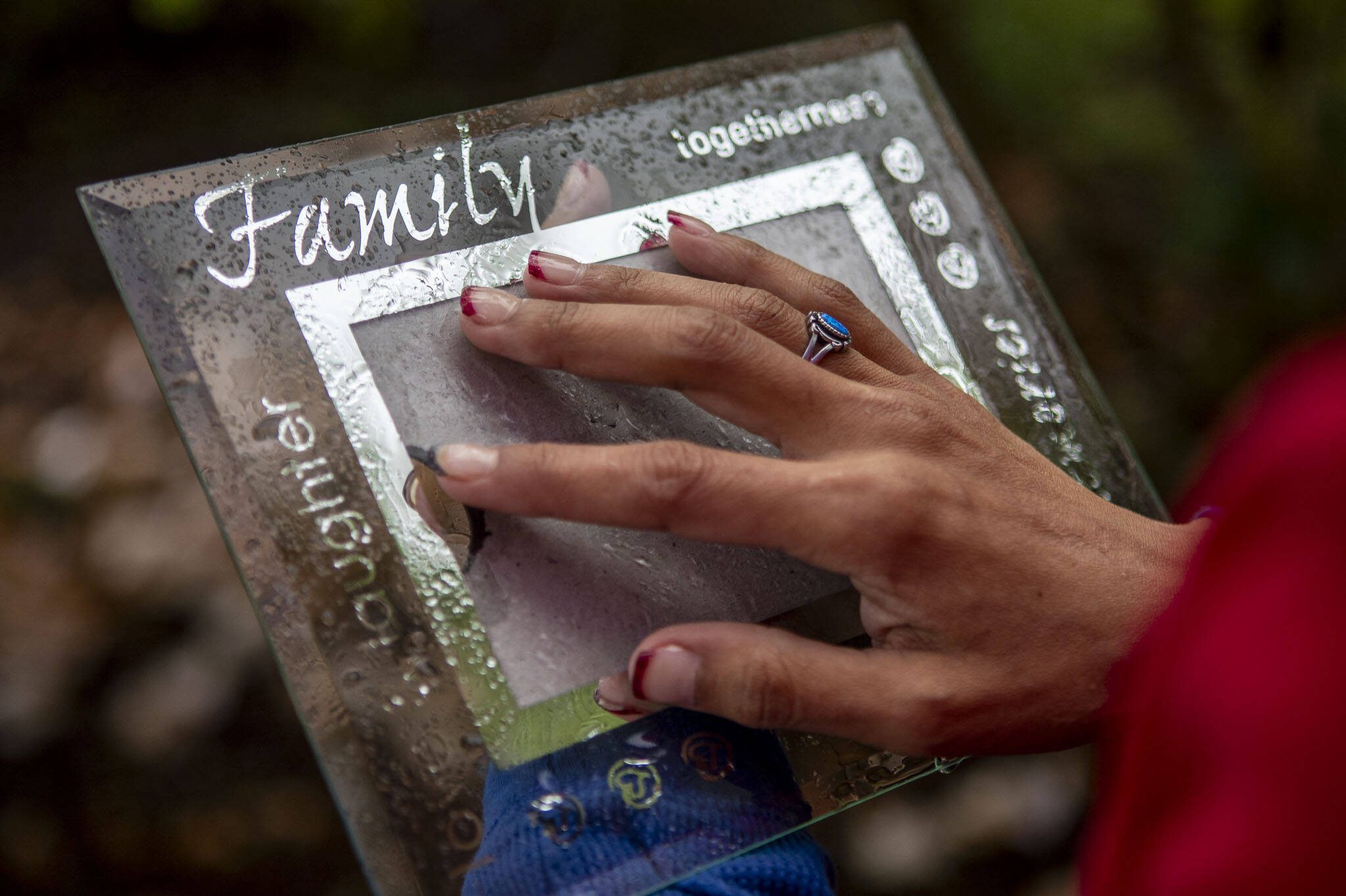 Gerry Davis holds an empty picture frame which she intends to put a photo of her sister Mary at Hillcrest Park in Mount Vernon, Washington on Wednesday, May 29, 2024. (Annie Barker / The Herald)