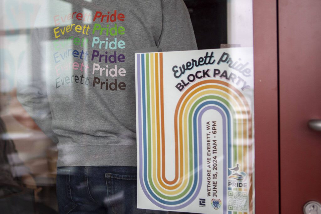 Everett Pride board member Kevin Daniels poses to show their sweatshirt for a photo at South Fork Bakery in Everett, Washington on Sunday, May 26, 2024. (Annie Barker / The Herald)
