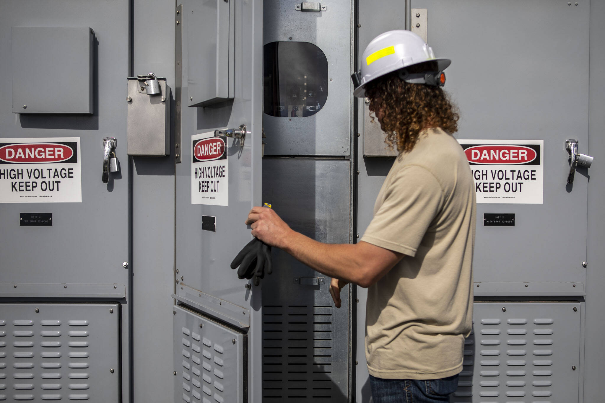 PUD employee Kyle Tucker opens part of the breaker system at the Jennings Park Substation in Marysville, Washington on Wednesday, June 5, 2024. (Annie Barker / The Herald)