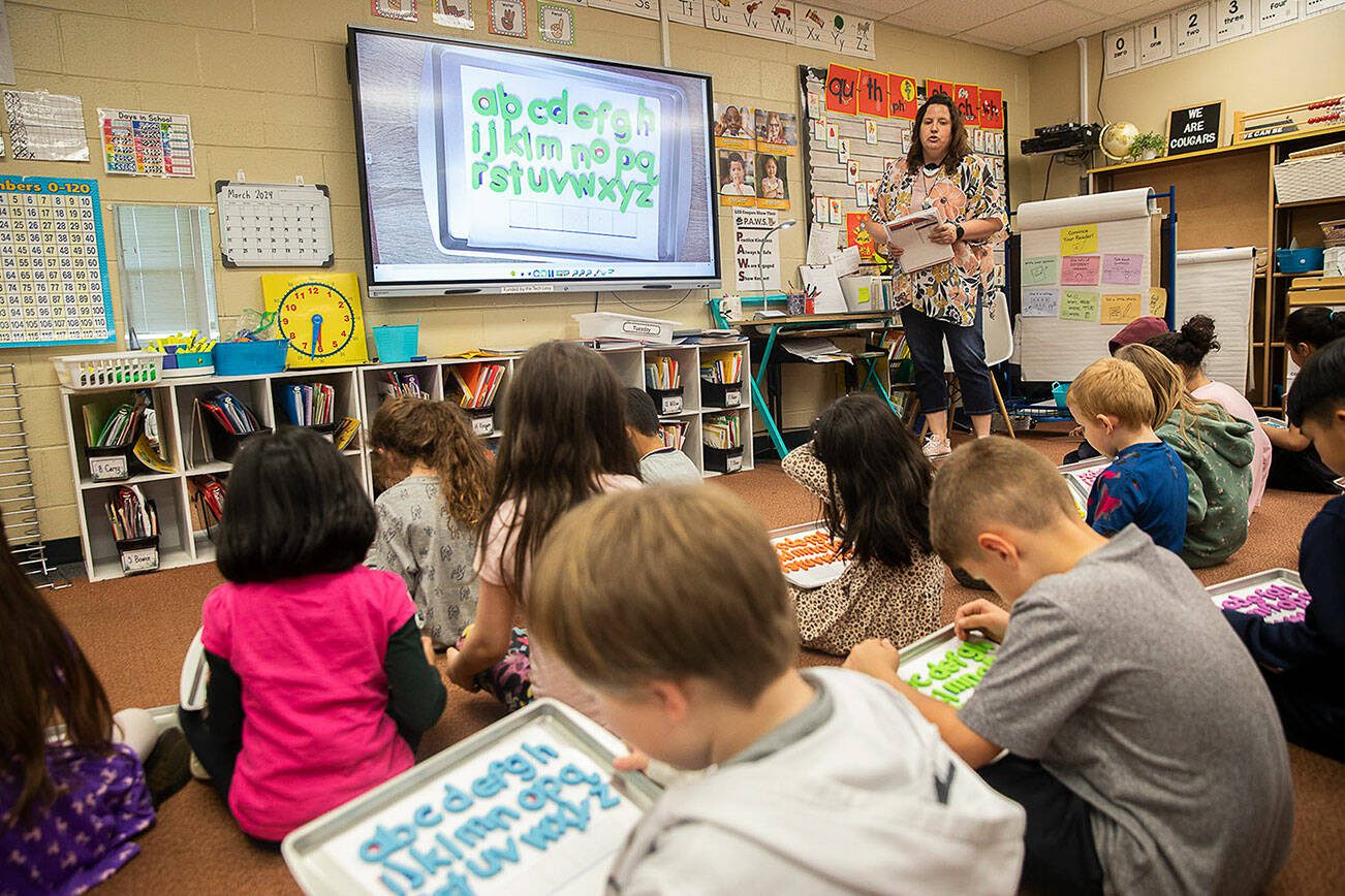 Mrs. Hildenbrand runs through a spelling exercise with her first grade class on the classroom’s Boxlight interactive display board funded by a pervious tech levy on Tuesday, March 19, 2024 in Marysville, Washington. (Olivia Vanni / The Herald)