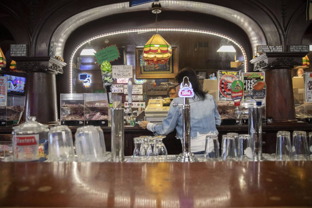 Denise McKenzie, a bartender at Kuhnle’s Tavern for many years, works behind the bar on June 17, 2024 in Marysville. (Olivia Vanni / The Herald)
