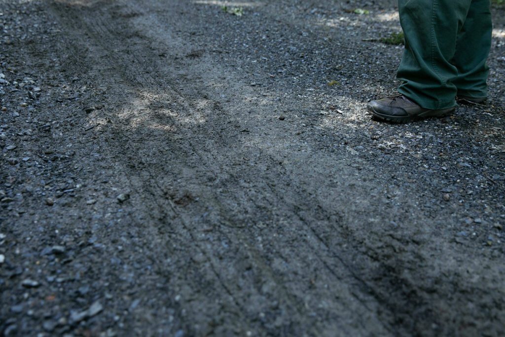Tire treads can be seen in the mucky gravel of Mountain Loop Highway on Thursday, June 6, 2024, in rural Snohomish County, Washington. (Ryan Berry / The Herald)
