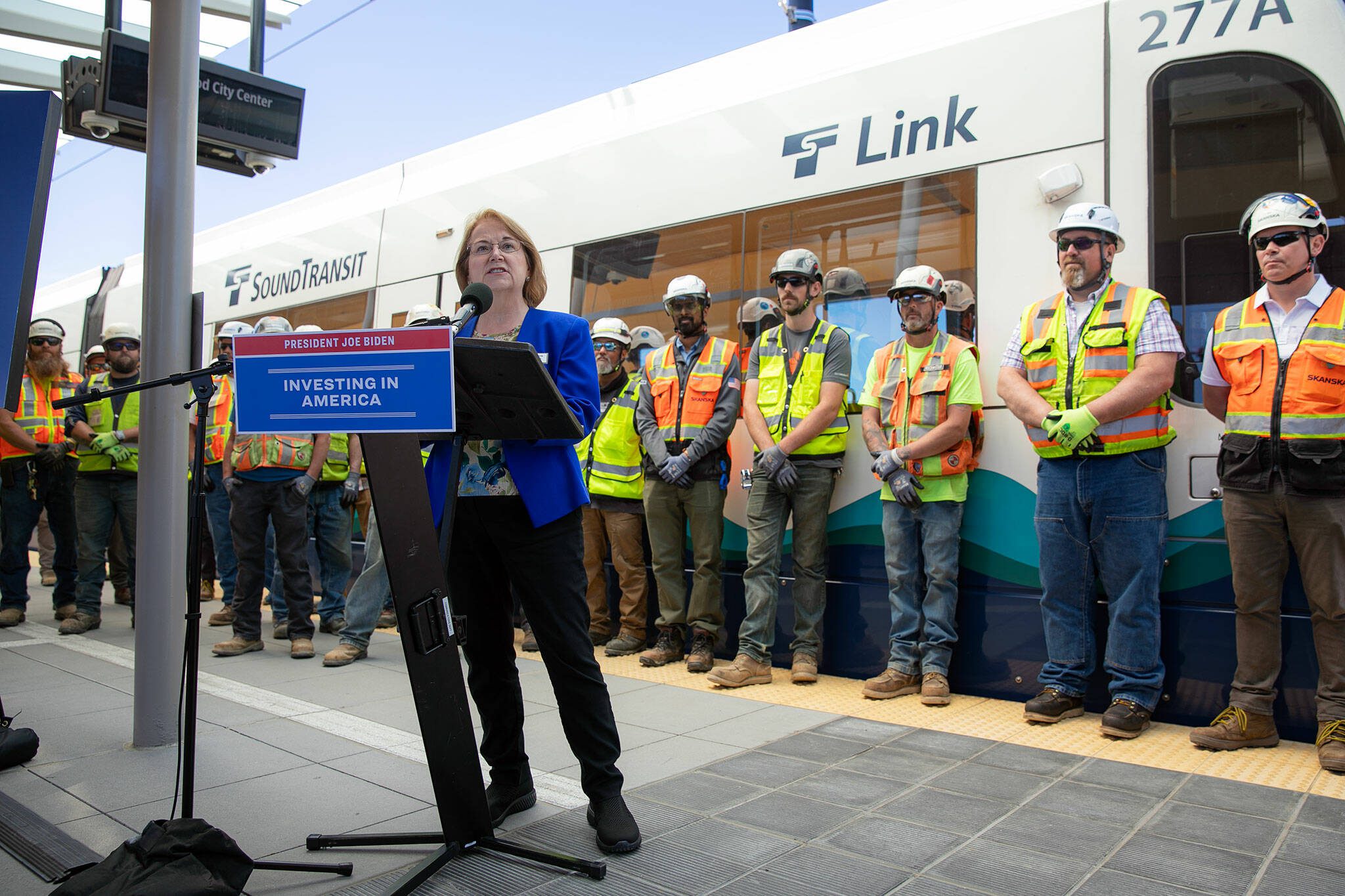 Lynnwood Mayor Christine Frizzell addresses a platform full of press, officials and construction workers during a press event at the Lynnwood City Center Link Station on Friday, June 7, 2024, in Lynnwood, Washington. (Ryan Berry / The Herald)