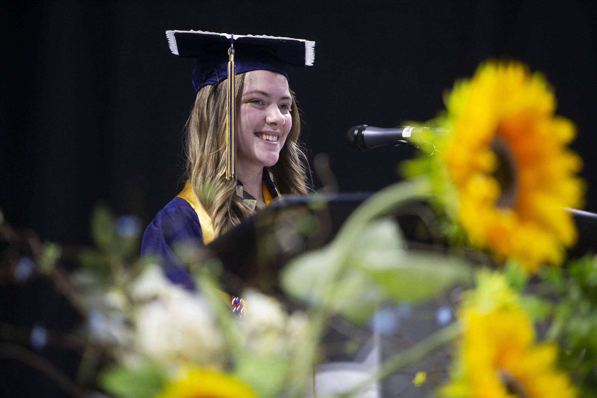Alyssa Acosta smiles during her valedictorian speech during Arlington High School’s graduation at Angel of the Winds Arena on Thursday, June 13, 2024, in Everett, Washington. (Olivia Vanni / The Herald)