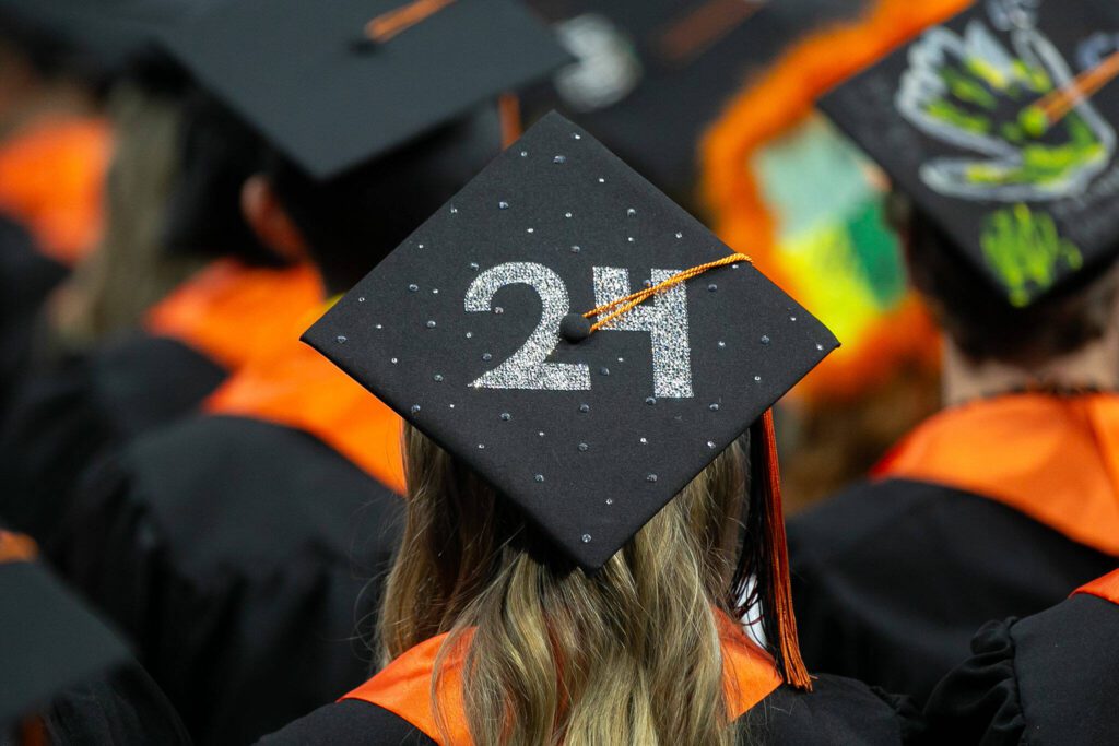 A graduate’s mortarboard bares a sparkling “24” during Monroe High School’s 2024 commencement on Wednesday, June 12, 2024, at Angel of the Winds Arena in Everett, Washington. (Ryan Berry / The Herald)
