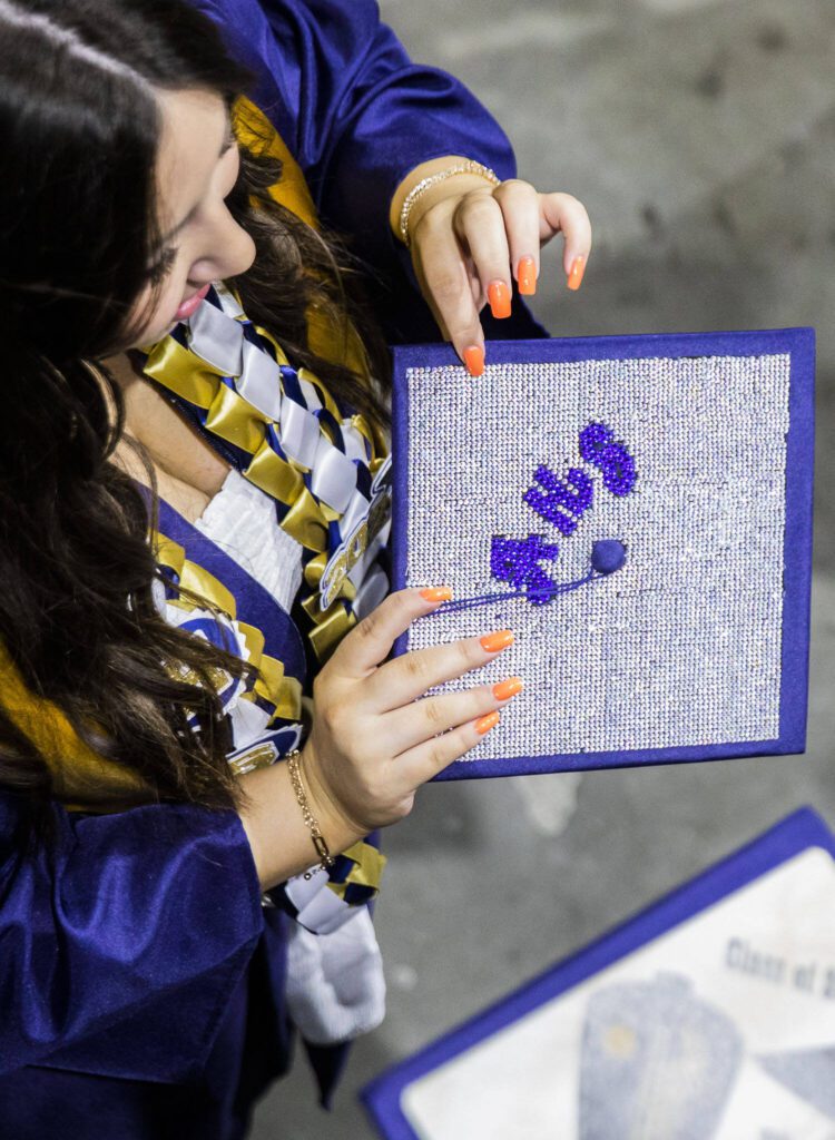 A crystal covered graduation cap shimmers during Arlington High School graduation at Angel of the Winds Arena on Thursday, June 13, 2024, in Everett, Washington. (Olivia Vanni / The Herald)
