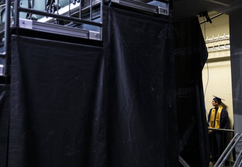 Boedan Ulicny lines up underneath the main concourse before the start of Arlington High School graduation at Angel of the Winds Arena on Thursday, June 13, 2024, in Everett, Washington. (Olivia Vanni / The Herald)
