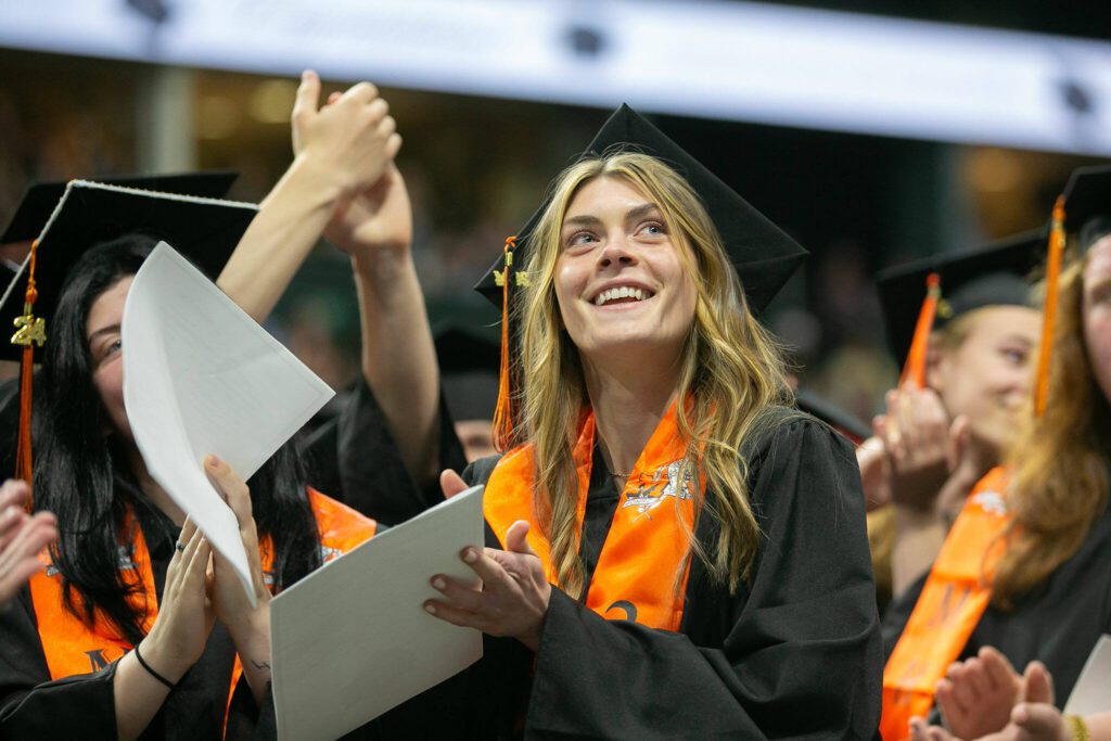 Graduates applaud their families during Monroe High School’s 2024 commencement on Wednesday, June 12, 2024, at Angel of the Winds Arena in Everett, Washington. (Ryan Berry / The Herald)
