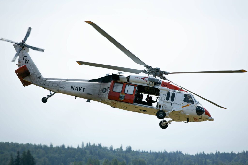 A NAS Whidbey Island Search and Rescue MH-60 Seahawk speeds off for another mission during an interagency training session held by Northwest Regional Aviation on Thursday, June 13, 2024, at the Arlington Airport in Arlington, Washington. (Ryan Berry / The Herald)
