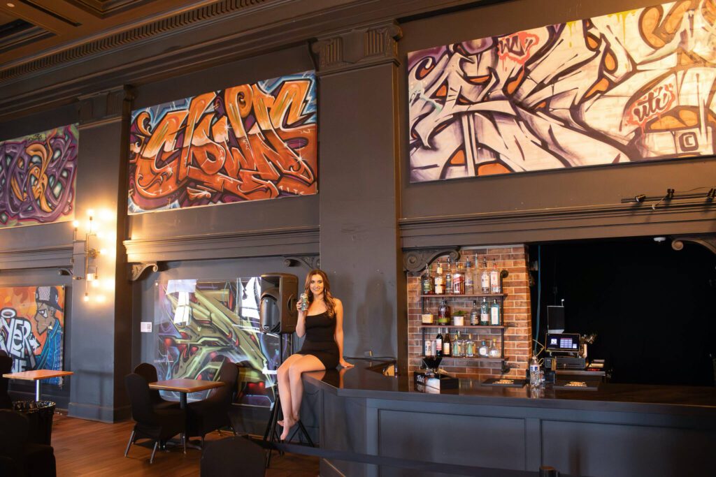 Gloryanne “Baby G” Carswell in the APEX Art & Culture Center with Diamond Knot Brewing’s Dogtown Collection, a collaboration with the venue. (Leland Dart Photography)
