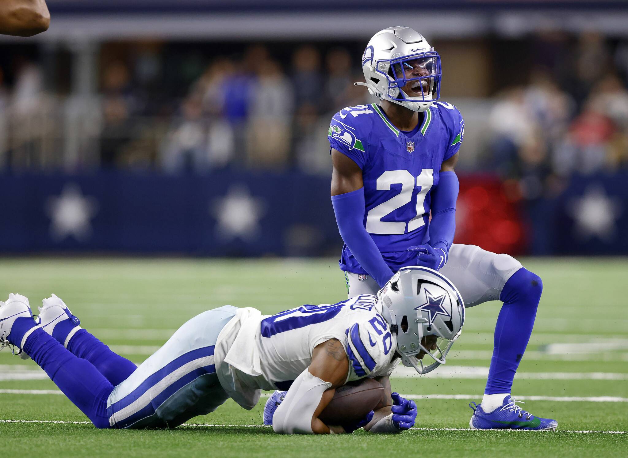 Seattle Seahawks cornerback Devon Witherspoon (21) celebrates a stop of Dallas Cowboys running back Tony Pollard (20) during the fourth quarter at AT&T Stadium in Arlington, Nov. 30, 2023. The Cowboys won, 41-35. (Tom Fox / Tribune News Service)