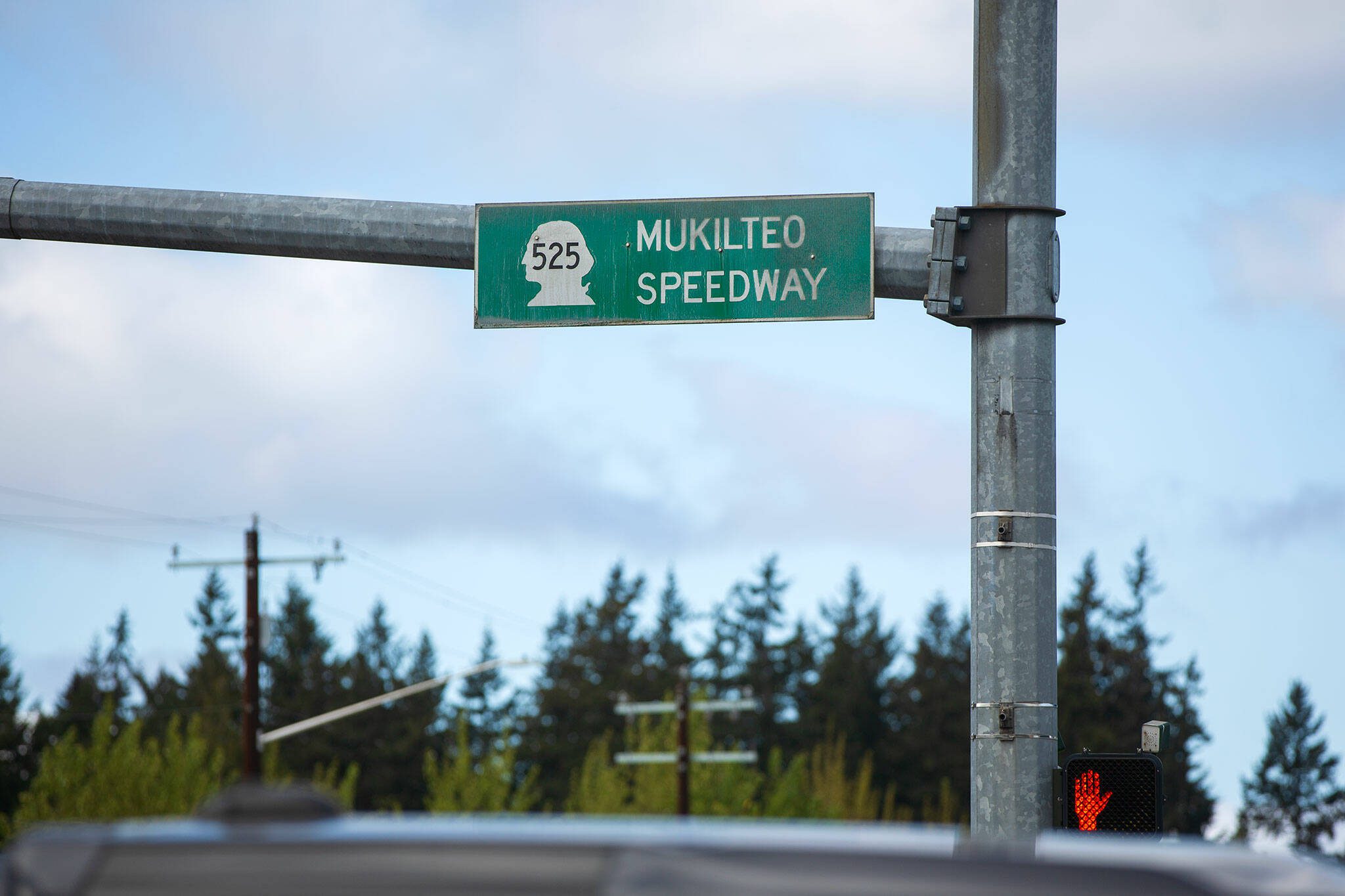 A Mukilteo Speedway sign hangs at an intersection along the road on Sunday, April 21, 2024, in Mukilteo, Washington. (Ryan Berry / The Herald)