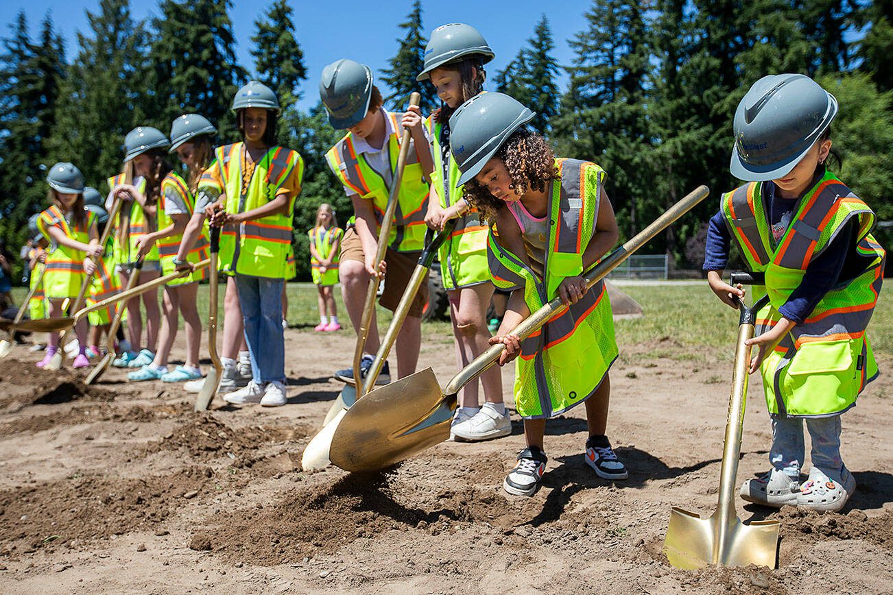 Naiyah Smith, 6, uses a large golden shovel to break ground with a handful of her school mates at Oak Heights Elementary on Tuesday, June 25, 2024 in Lynnwood, Washington. (Olivia Vanni / The Herald)