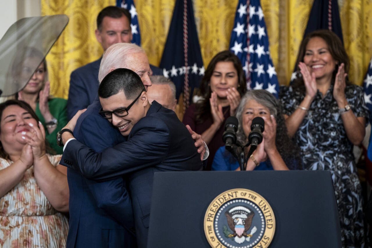 President Joe Biden hugs Javier Quiroz Castro, who benefitted from the Deferred Action for Childhood Arrivals program, during an anniversary event for DACA in the East Room at the White House on June 18. President Biden on Tuesday announced sweeping new protections for hundreds of thousands of immigrants who have been living in the United States illegally for years but are married to American citizens. (Haiyun Jiang / The New York Times)