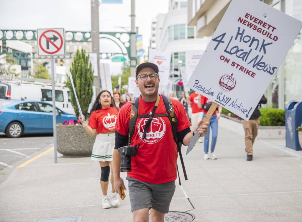 Ryan Berry leads a chant as he makes his way down Colby Avenue during the Everett NewsGuild strike on Monday, June 24, 2024, in Everett, Washington. (Olivia Vanni / The Herald)
