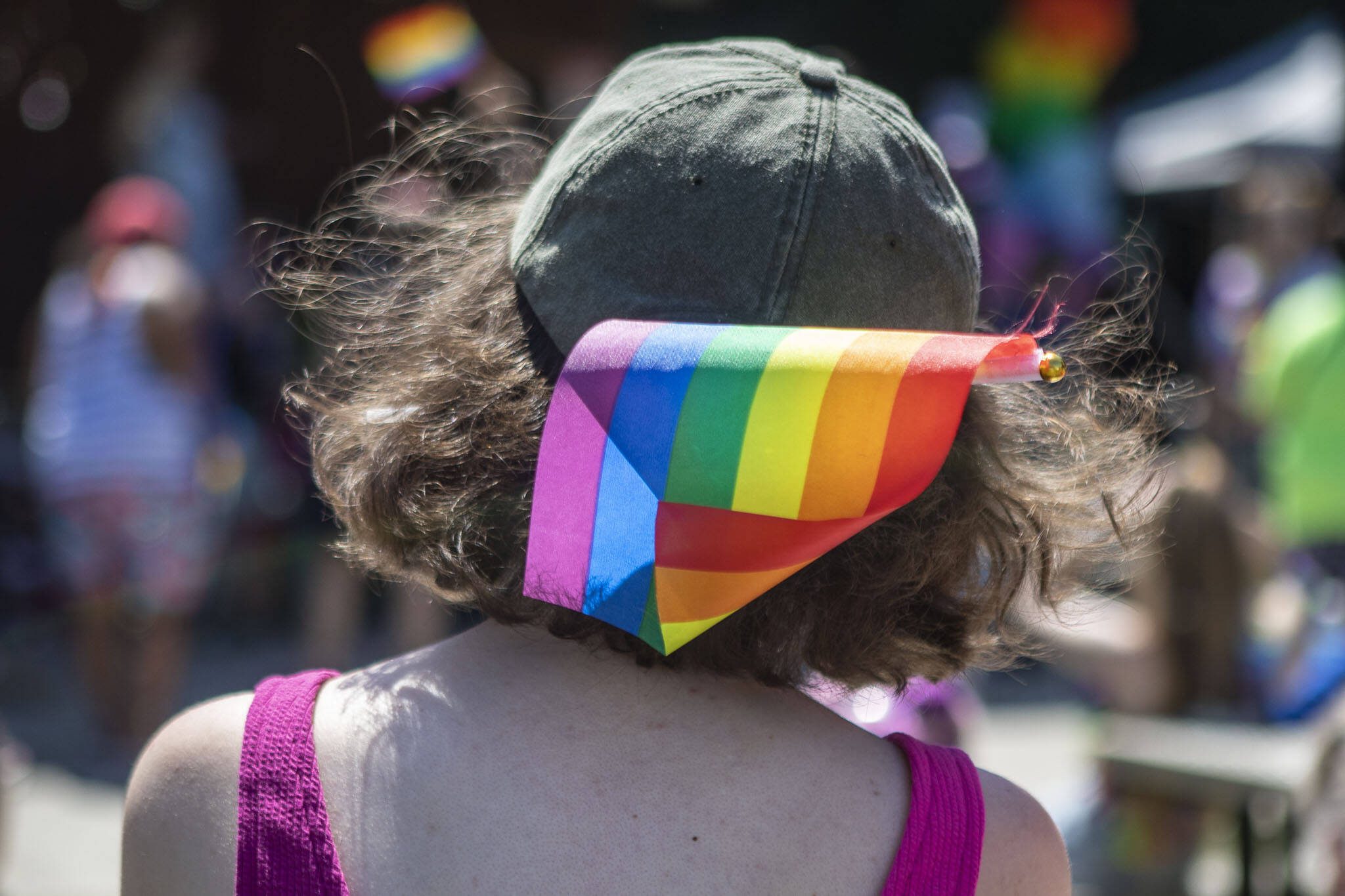 A person wears a pride flag in their hat during the second annual Arlington Pride at Legion memorial Park in Arlington, Washington, on Saturday, July 22, 2023. (Annie Barker / The Herald)