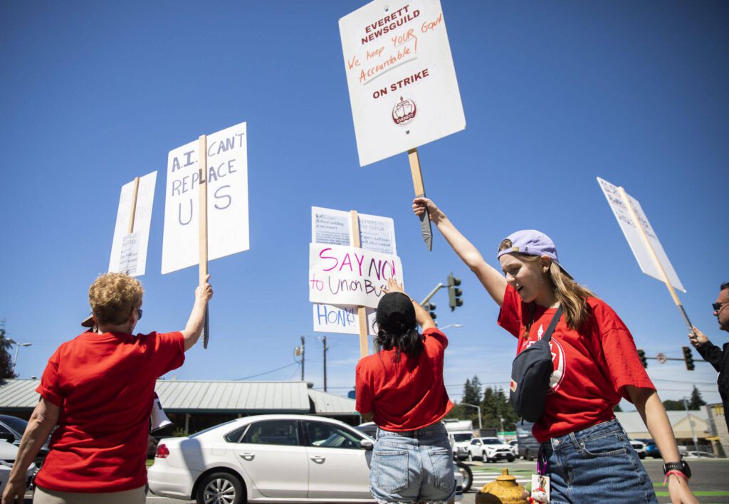 Jenelle Baumbach, right, holds a sign and chants during the second day of the Everett NewsGuild’s strike on Tuesday, June 25, 2024 in Everett, Washington. (Olivia Vanni / The Herald)
