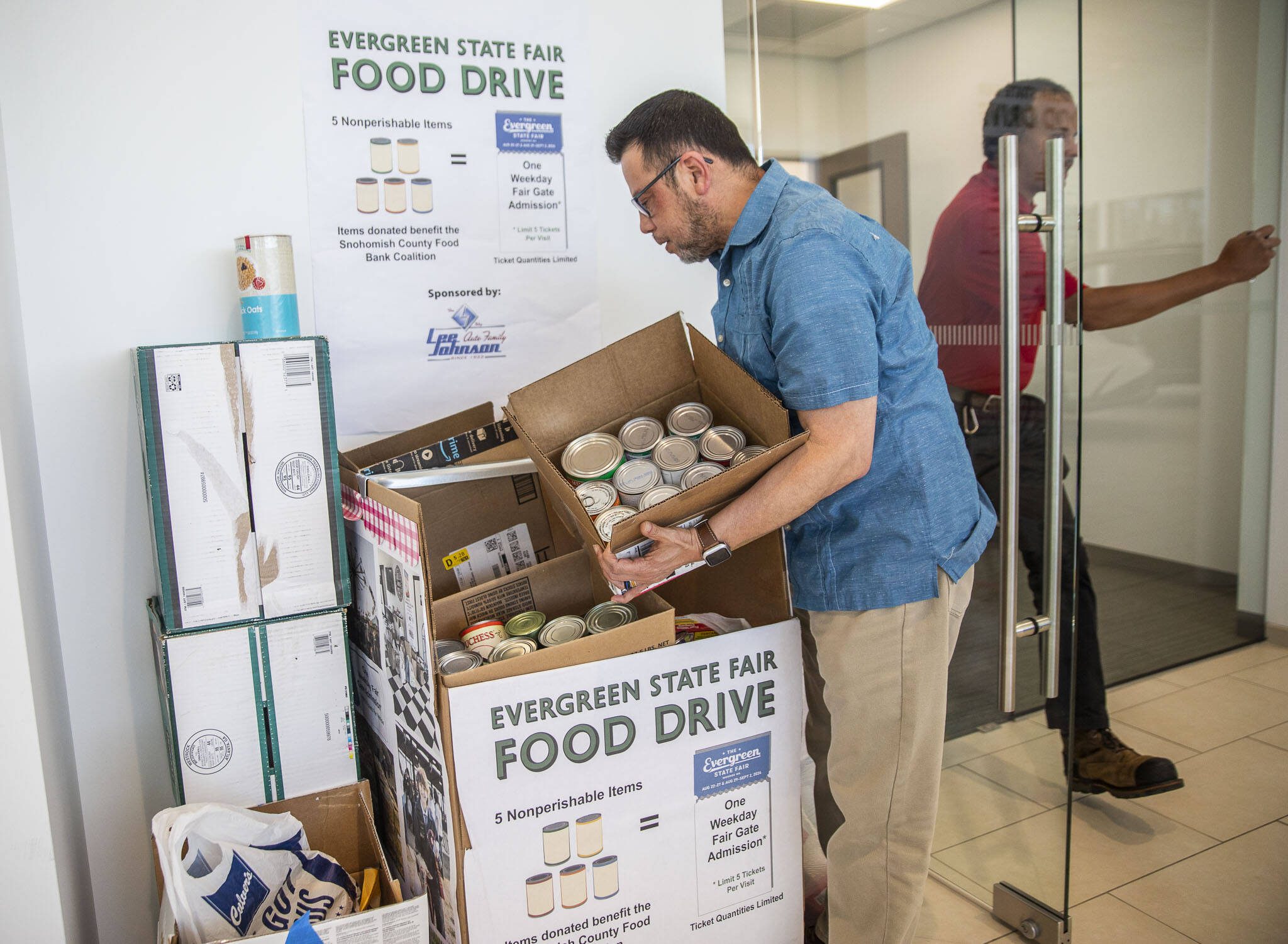 Robert Fabia, a sales manger at Lee Johnson Hyundai of Everett, shows some of the donations they have received on Tuesday, June 25, 2024 in Everett, Washington. (Olivia Vanni / The Herald)