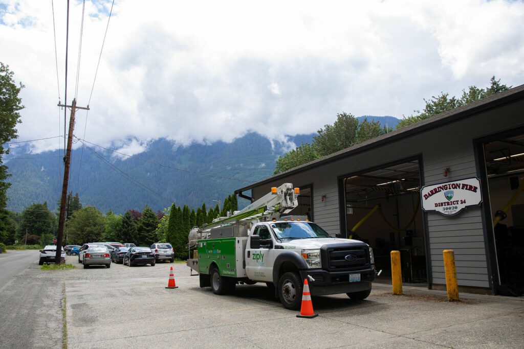 A Ziply Fiber truck is parked outside Darrington Fire District Station 38 during a press conference and groundbreaking for the SR 530 Broadband Project on Wednesday, June 26, 2024, outside Darrington, Washington. (Ryan Berry / The Herald)
