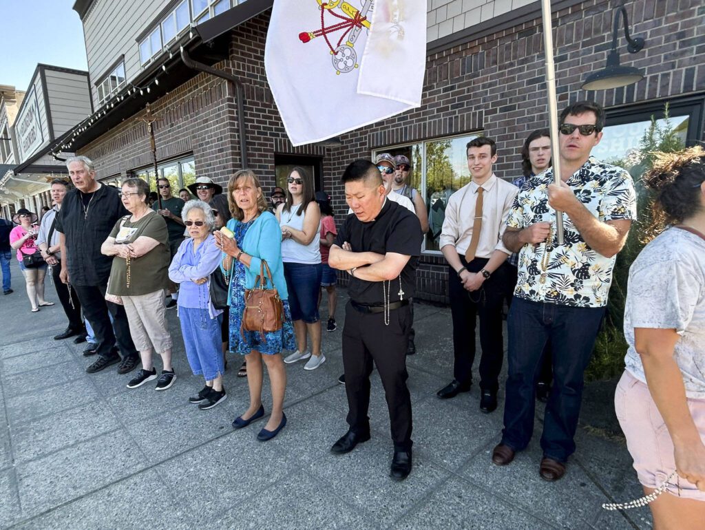 Protestors gather in prayer outside of Arlington Hardware on July 22, 2023 in Arlington, Washington. (Jordan Hansen / The Herald)
