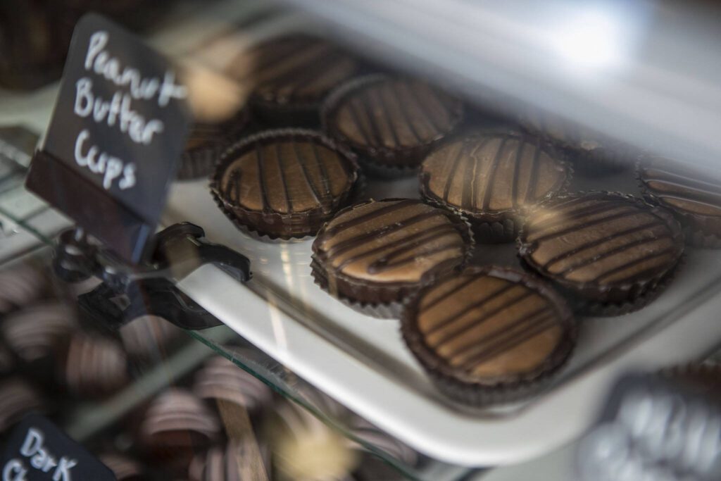 Peanut butter cups are displayed inside Sweet Mona’s Chocolates. (Annie Barker / The Herald)
