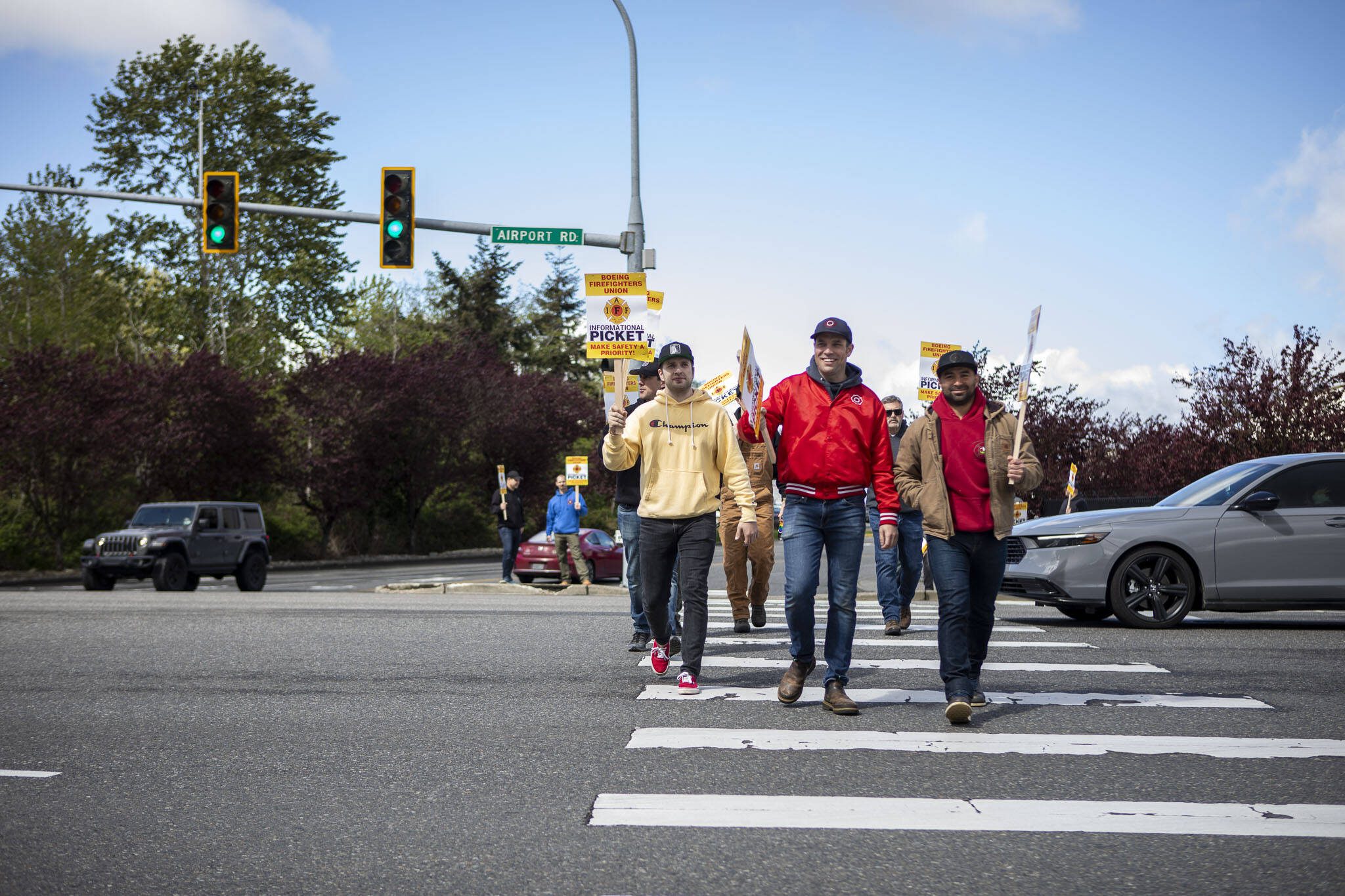 Members of the Boeing firefighters union and supporters hold an informational picket at Airport Road and Kasch Park Road on Monday, April 29, 2024 in Everett, Washington. (Annie Barker / The Herald)
Boeing firefighters union members and supporters cross the street while holding an informational picket at Airport Road and Kasch Park Road on Monday, April 29, 2024 in Everett, Washington. (Annie Barker / The Herald)