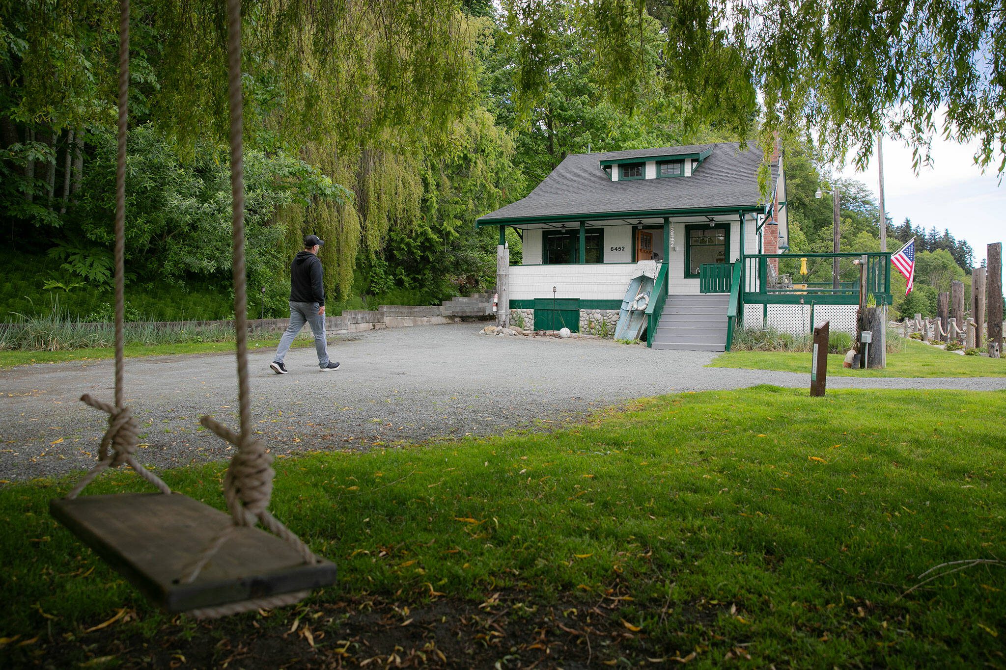Owner Ryan Anderson, a contractor who worked on the property himself, walks up the driveway at Ferry Cove on May 29, 2024, in Clinton. (Ryan Berry / The Herald)
