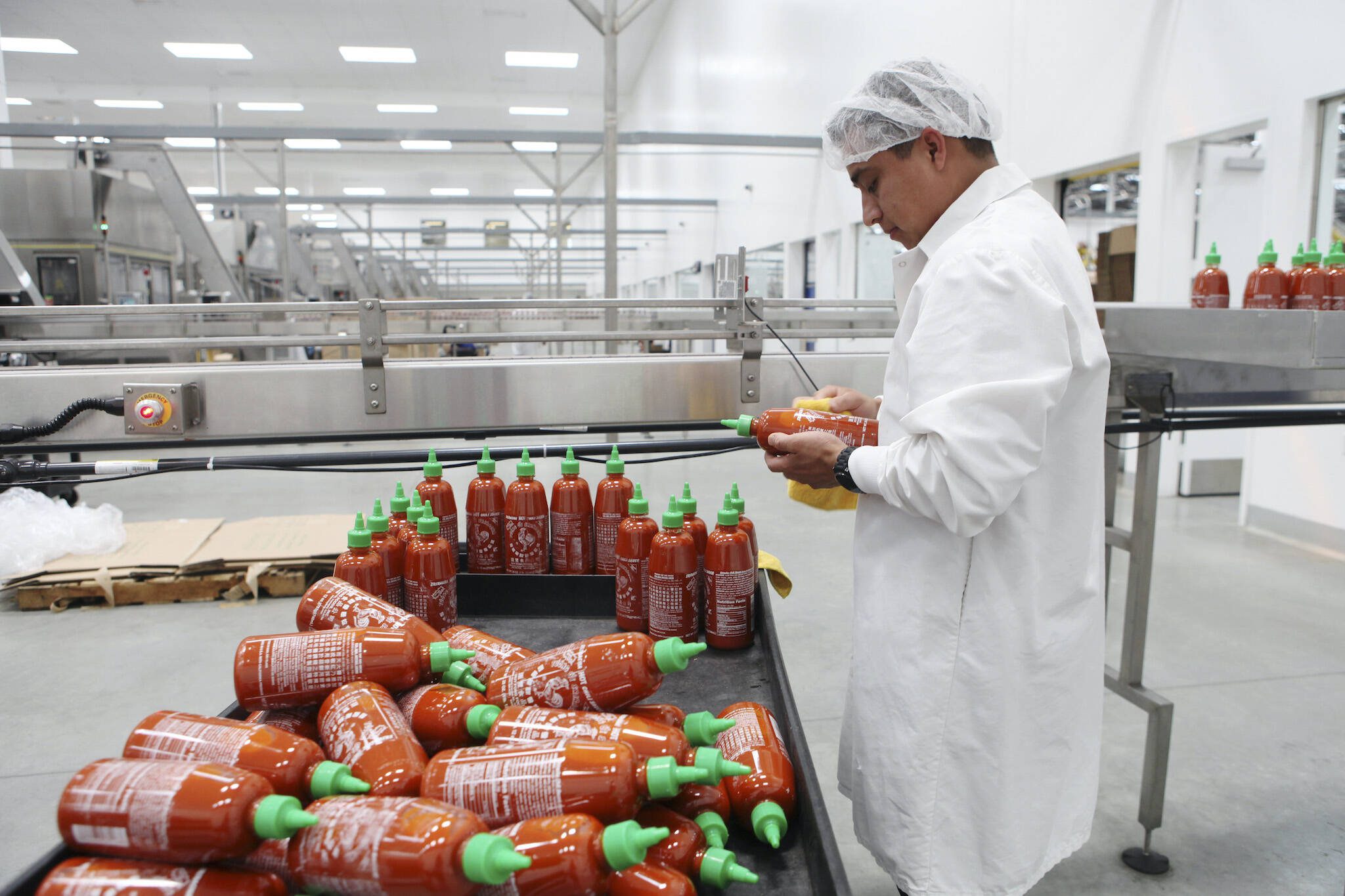A production line of Sriracha hot sauce at Huy Fong Foods in Irwindale, Calif., on April 28, 2014. Huy Fong, the maker of the most popular variety of Sriracha sauce, told distributors in May 2024 that it would halt production of all its products until at least September, rekindling fears of another prolonged shortage of the beloved condiment. (Emily Berl/The New York Times)