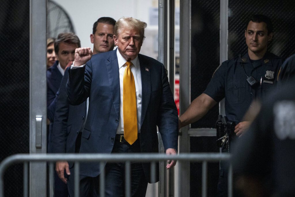 Former President Donald Trump raises a fist as he walks to the courtroom after the jury had a question for the judge amid deliberations in his criminal trial at the New York State Supreme Court in Manhattan, Wednesday, May 29, 2024. (Doug Mills/The New York Times)
