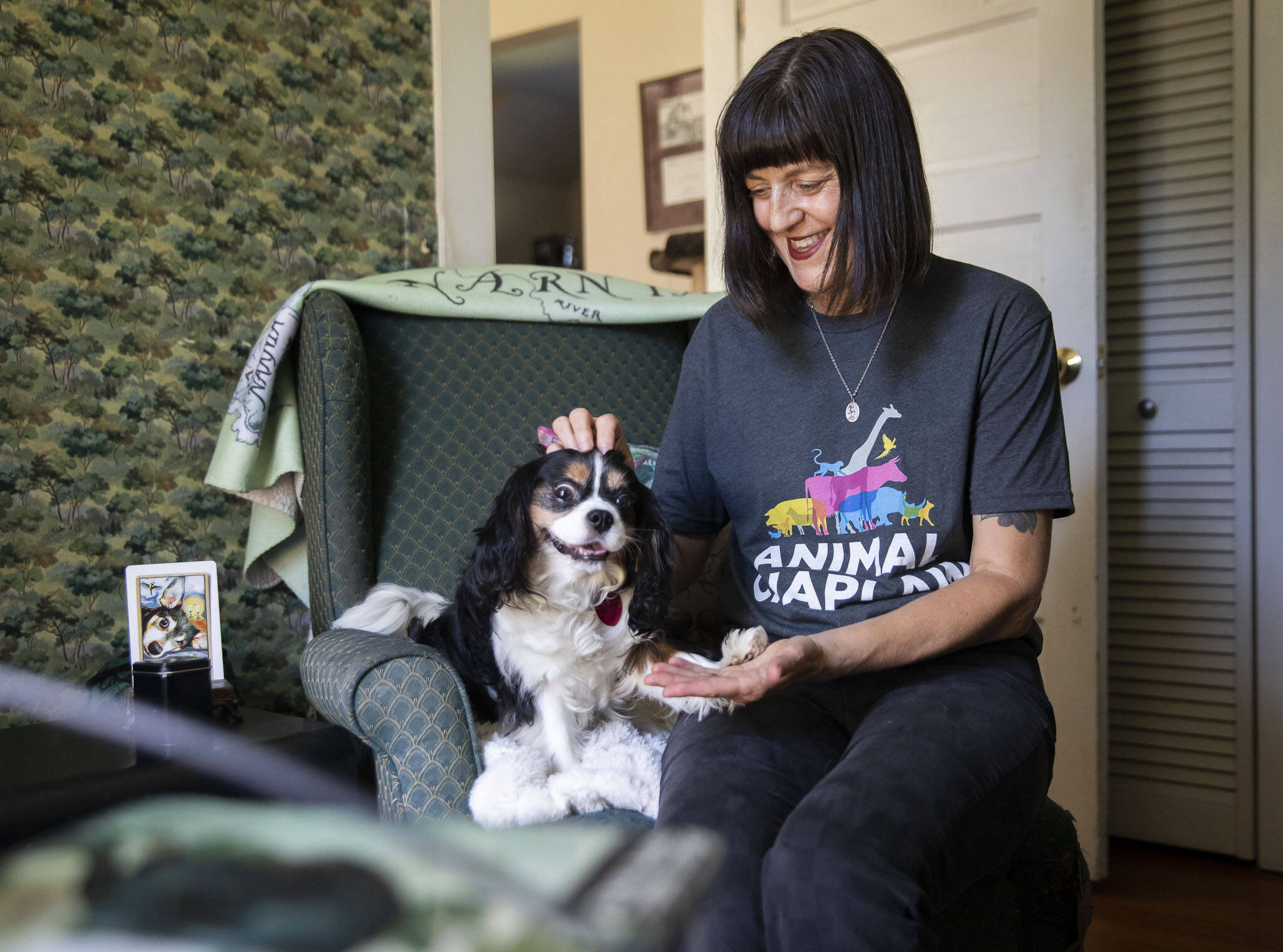 Animal chaplain Shel Graves has her dog Lily pose for a photo in her home office on July 9, 2024 in Everett. (Olivia Vanni / The Herald)