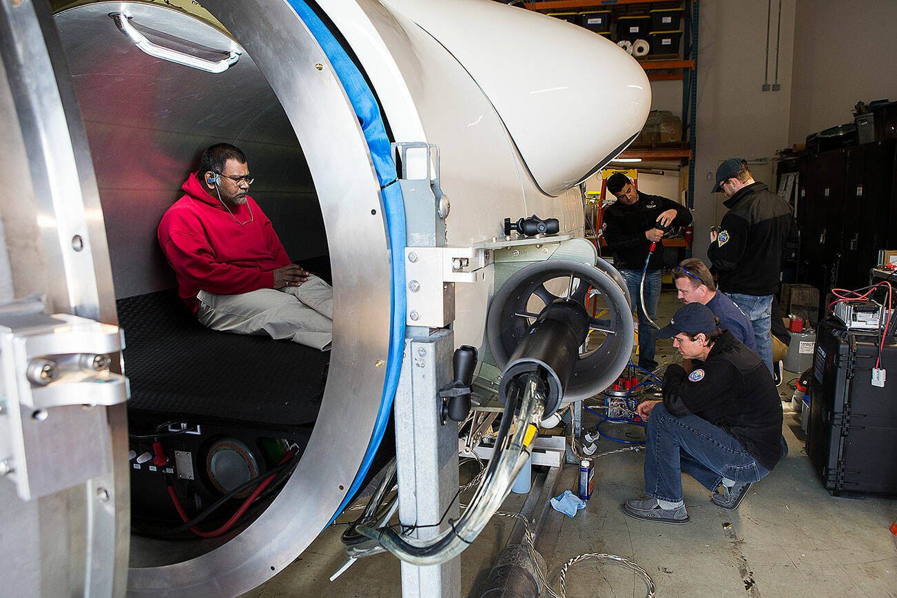 OceanGate engineer Mark Walsh programs control software as engineering technicians get the Titan submersible ready for testing on March 12, 2018, in Everett, Washington. (Andy Bronson / The Herald file)
OceanGate engineer Mark Walsh programs control software as engineering technicians get the Titan submersible ready for testingngineers get the Titan submersible ready for testing on Monday, March 12, 2018 in Everett, Wa. (Andy Bronson / The Herald)