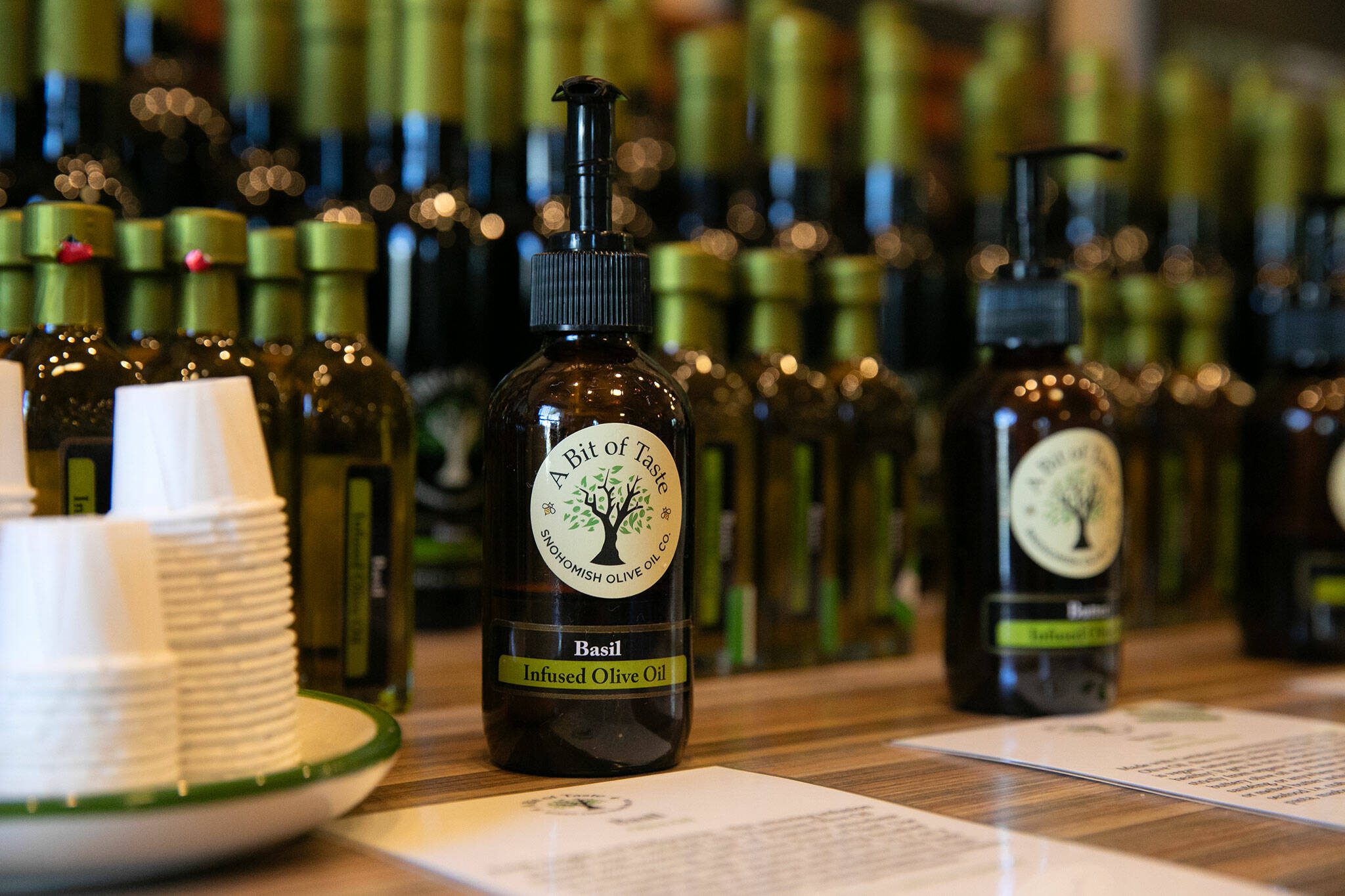 Dozens of samples of olive oil and balsamic vinegar line the “Wall of Flavor” at A Bit of Taste on Wednesday, June 12, 2024, in Snohomish, Washington. (Ryan Berry / The Herald)