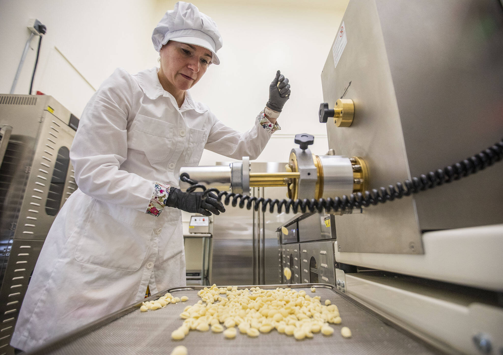 Aurora Echo, owner of Wildly Beloved Foods, begins making cavatelli pasta with one of her Bottene pasta machine on Thursday, June 27, 2024 in Clinton, Washington. (Olivia Vanni / The Herald)