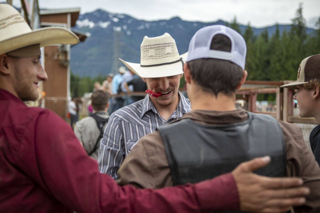 Cowboys congratulate each other during the Timberbowl Rodeo in Darrington, Washington, on Saturday, June 29, 2024. (Annie Barker / The Herald)
