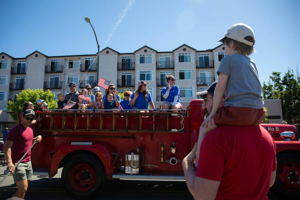 An old fire engine goes by during Everett’s Fourth of July Parade on Thursday, July 4, 2024, in downtown Everett, Washington. (Ryan Berry / The Herald)
