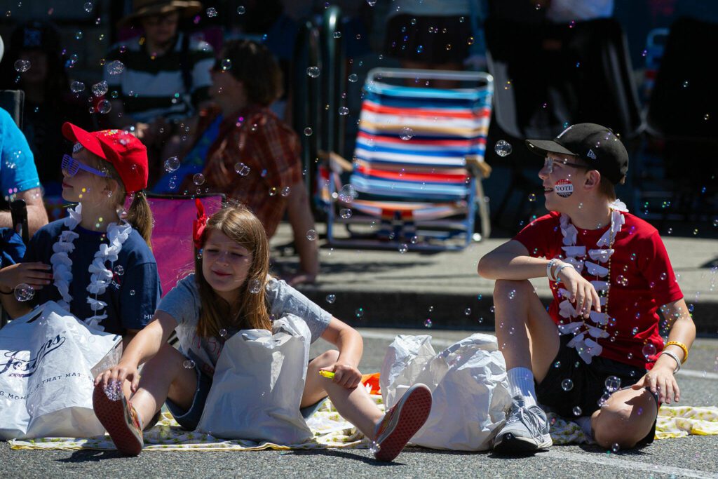 Bubbles shroud onlookers during Everett’s Fourth of July Parade on Thursday, July 4, 2024, in downtown Everett, Washington. (Ryan Berry / The Herald)
