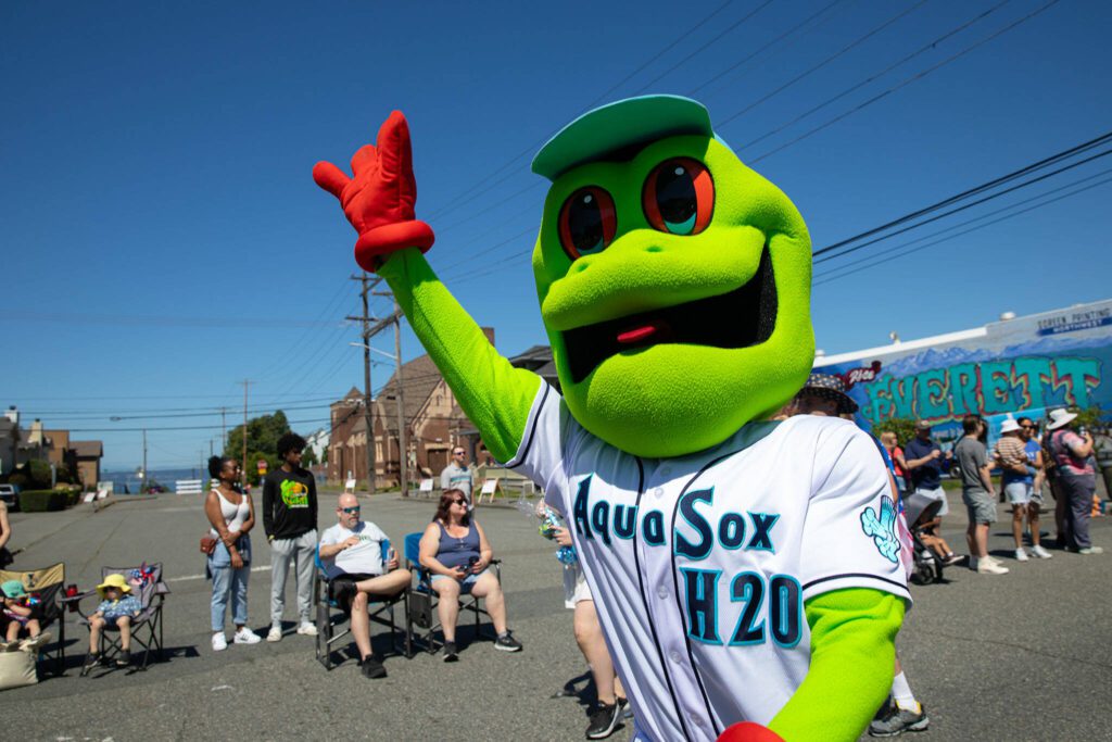 AquaSox mascot Webbly waves to the crowd during Everett’s Fourth of July Parade on Thursday, July 4, 2024, in downtown Everett, Washington. (Ryan Berry / The Herald)
