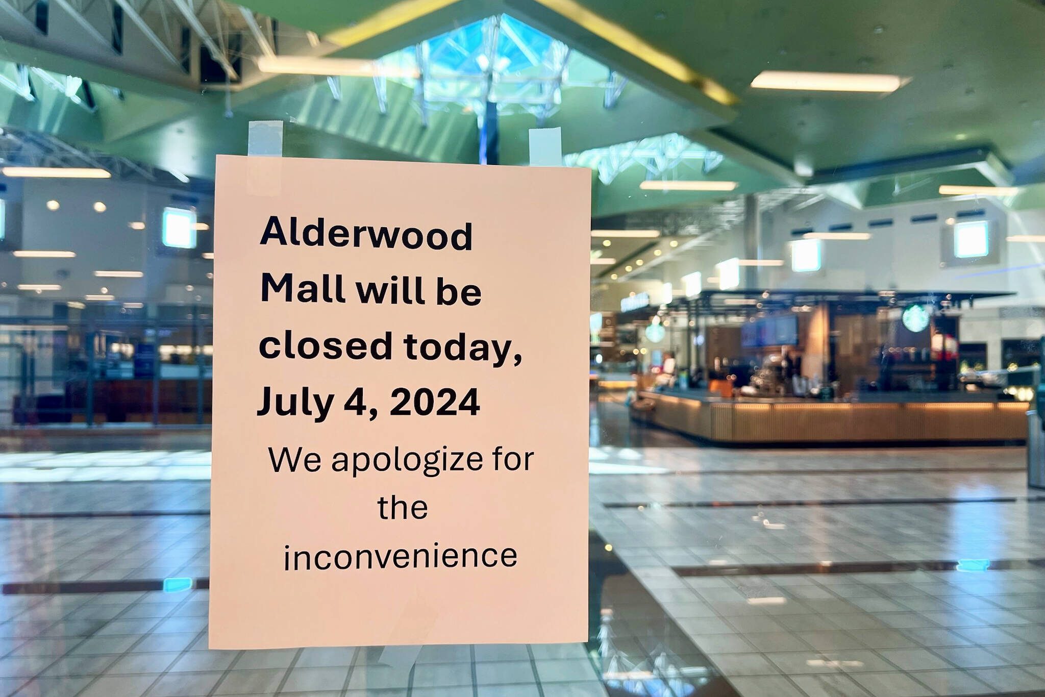 A sign seen from inside Macy’s informs customers that the Alderwood Mall is closed on Thursday, July 4, 2024, in Lynnwood, Washington (Andrea Brown / The Herald)