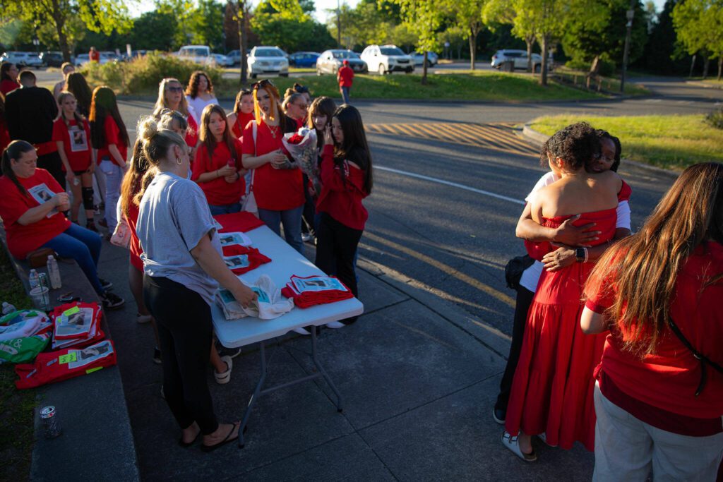People begin arriving for a vigil held in memory of Jayda Woods-Johnson at Mountlake Terrace High School on Sunday, July 7, 2024, in Mountlake Terrace, Washington. Shirts with a memorial to Jayda printed on them were given out. (Ryan Berry / The Herald)
