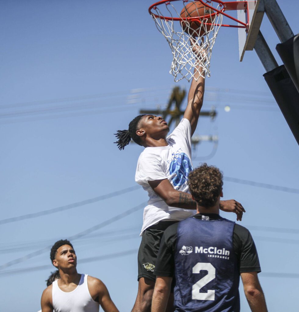 FAB and WeAreEverett face off in the 18 and older mens bracket during the Everett 3on3 tournament in downtown Everett, Washington on Sunday, July 14, 2024. (Annie Barker / The Herald)
