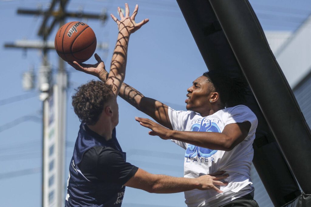 FAB and WeAreEverett face off in the 18 and older mens bracket during the Everett 3on3 tournament in downtown Everett, Washington on Sunday, July 14, 2024. (Annie Barker / The Herald)
