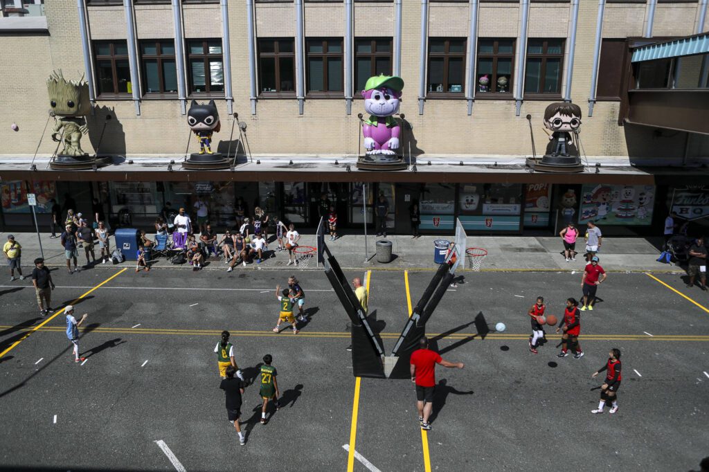 Players warm up and play games during the Everett 3on3 tournament in downtown Everett, Washington on Sunday, July 14, 2024. (Annie Barker / The Herald)
