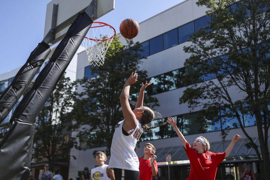 “MaMbA OUT” and the Basket Brawlers face off in the 8-9 year old male league during the Everett 3on3 tournament in downtown Everett, Washington on Sunday, July 14, 2024. (Annie Barker / The Herald)
