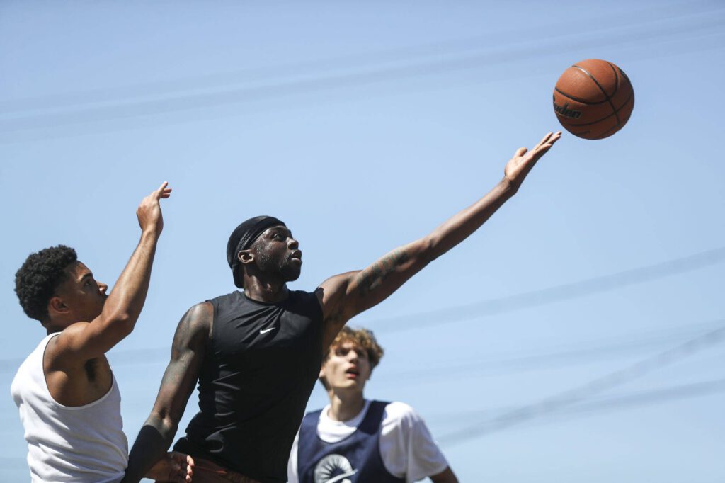 FAB and WeAreEverett face off in the 18 and older mens bracket during the Everett 3on3 tournament in downtown Everett, Washington on Sunday, July 14, 2024. (Annie Barker / The Herald)
