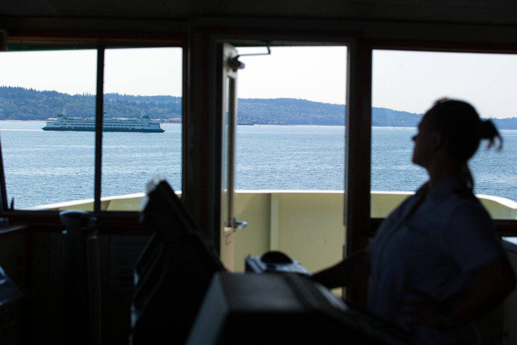 A Washington State Ferry passes by the MV Spokane on the Edmonds/Kingston ferry route Thursday, July 18, 2024, near Edmonds, Washington. (Ryan Berry / The Herald)
