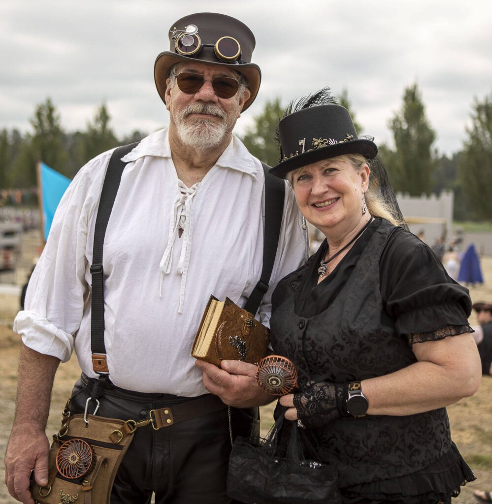 Mount Vernon residents Miles Baron, 64, left, and Lisa Case, 57, right, pose for a photo during the Washington Midsummer Renaissance Faire at Sky Meadows Park in Snohomish, Washington on Sunday, Aug. 6, 2023. (Annie Barker / The Herald)
