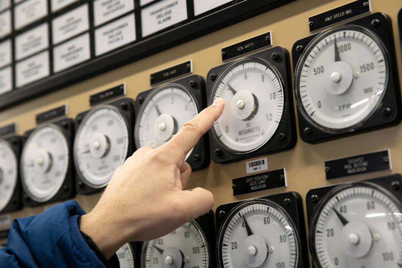 Scott Spahr, Generation Engineering Manager at A Snohomish County PUD employee points to a dial indicating 4 megawatts of power production from one of two Francis turbine units at the Henry M. Jackson Powerhouse in February, 2023, near Sultan. Some of the water that passes through units 3 and 4 — the two Francis turbines — is diverted to Lake Chaplain, which supplies water to Everett. (Ryan Berry / The Herald file photo)