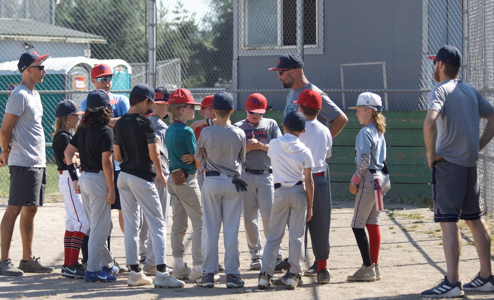 Boys Snohomish Little League 8-10 coach Aaron Barstad (center) talks to his team during practice at the Snohomish Little League Complex in Snohomish, Washington on Thursday, July 18, 2024. Barstad’s team claimed the Washington District 1 Little League title, securing a spot in the 2024 Washington State 8-10 Baseball tournament held July 20-27 at the North Kitsap League Complex in Poulsbo, Washington. (Taras McCurdie / The Herald)