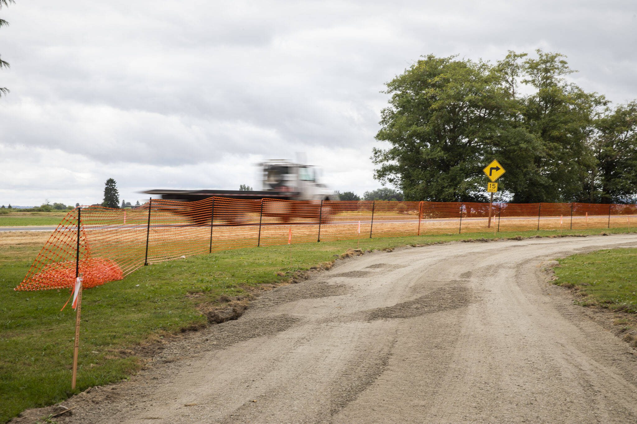 A truck drives past the second phase of the Port Susan Trail construction on Thursday, July 25, 2024 in Stanwood, Washington. (Olivia Vanni / The Herald)