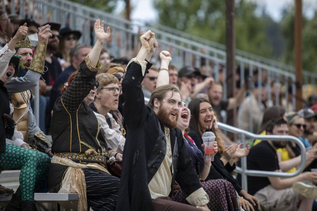 People cheer during the joust at the Washington Midsummer Renaissance Faire near Monroe on Sunday. (Annie Barker / The Herald)
